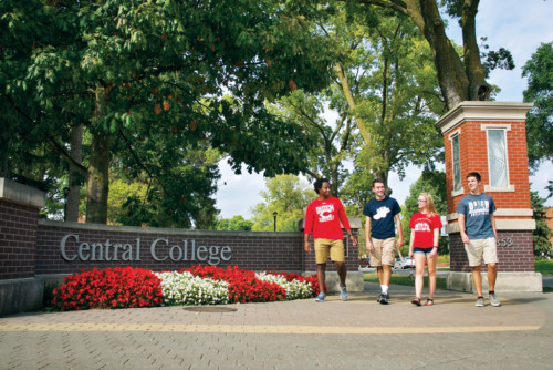 Central College students near a sign that reads "Central College"