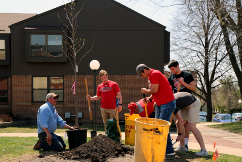 Central students plant a tree on campus during an Arbor Day observance in April 2018.