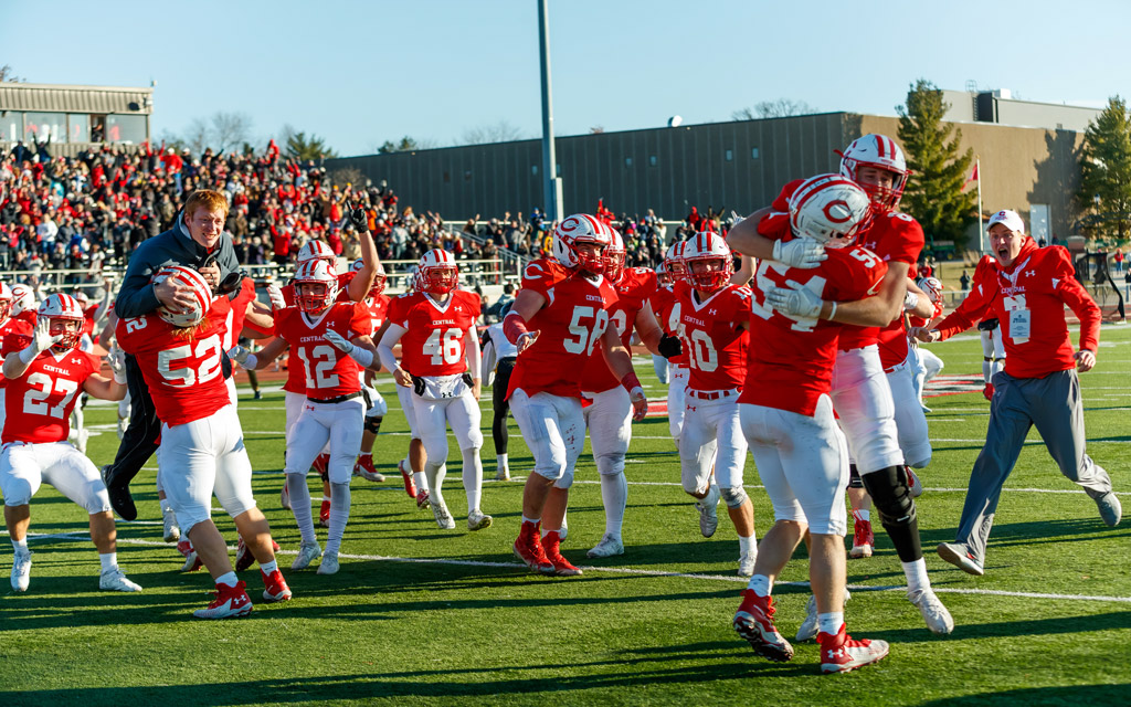Football team celebrates a victory in the NCAA Div. III playoffs