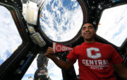 Raja Chari aboard the International Space Station, posing with a Central College pennant.