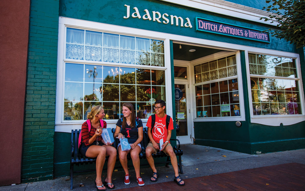 Central College students enjoying baked goods in front of Jaarsma bakery in Pella.
