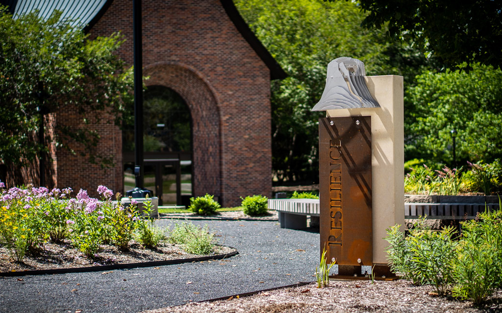 "Resilience" marker featured on the Central College Peace Mall. This marker depicts the bell salvaged from the Old Central building after a fire.