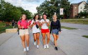Four Central students walking with thumbs up.