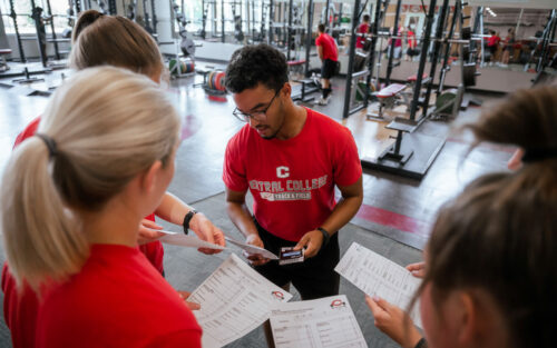 Kinesiology majors working together in the Central weight room.