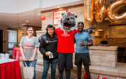 Central College students celebrating Hoo-Rah Day with mascot Big Red.