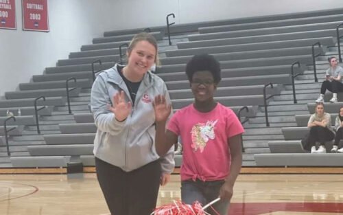 Sydni Huisman '23, left, welcomed Kid Captain Christine Ausman, right, at the Central women’s basketball game.