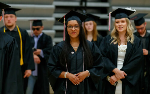 Students standing in P..H. Kuyper Gymnasium ready to graduate.