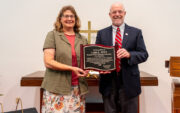 Lori Witt and Mark Putnam holding plaque