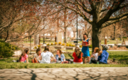 A group of students talking under a tree