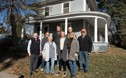 eight people standing outside the Prins House