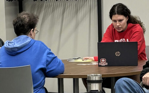 VITA student volunteer assisting a woman